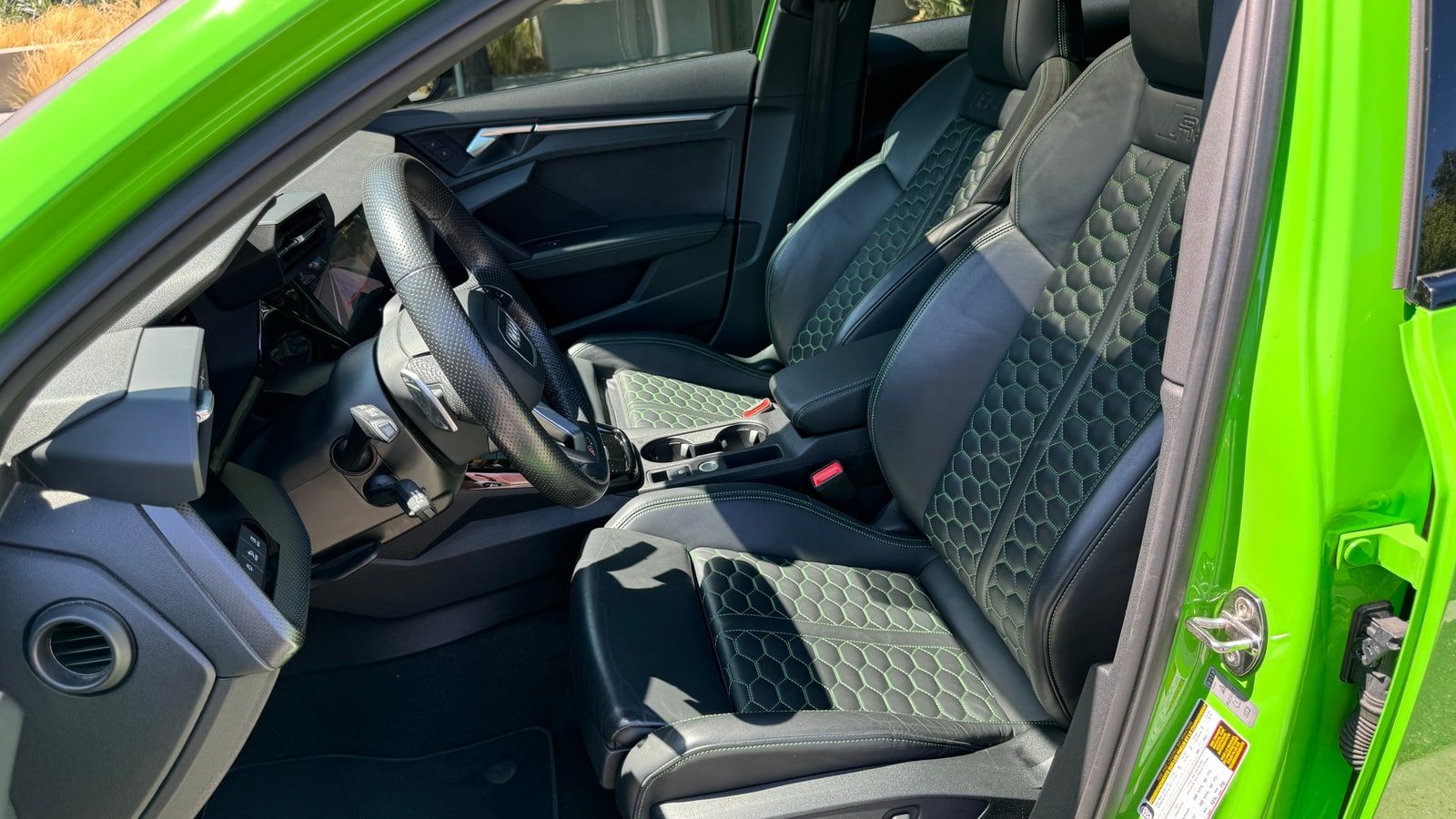Interior of the green Audi RS3 rental in Los Angeles, showing the honeycomb-quilted sport seats