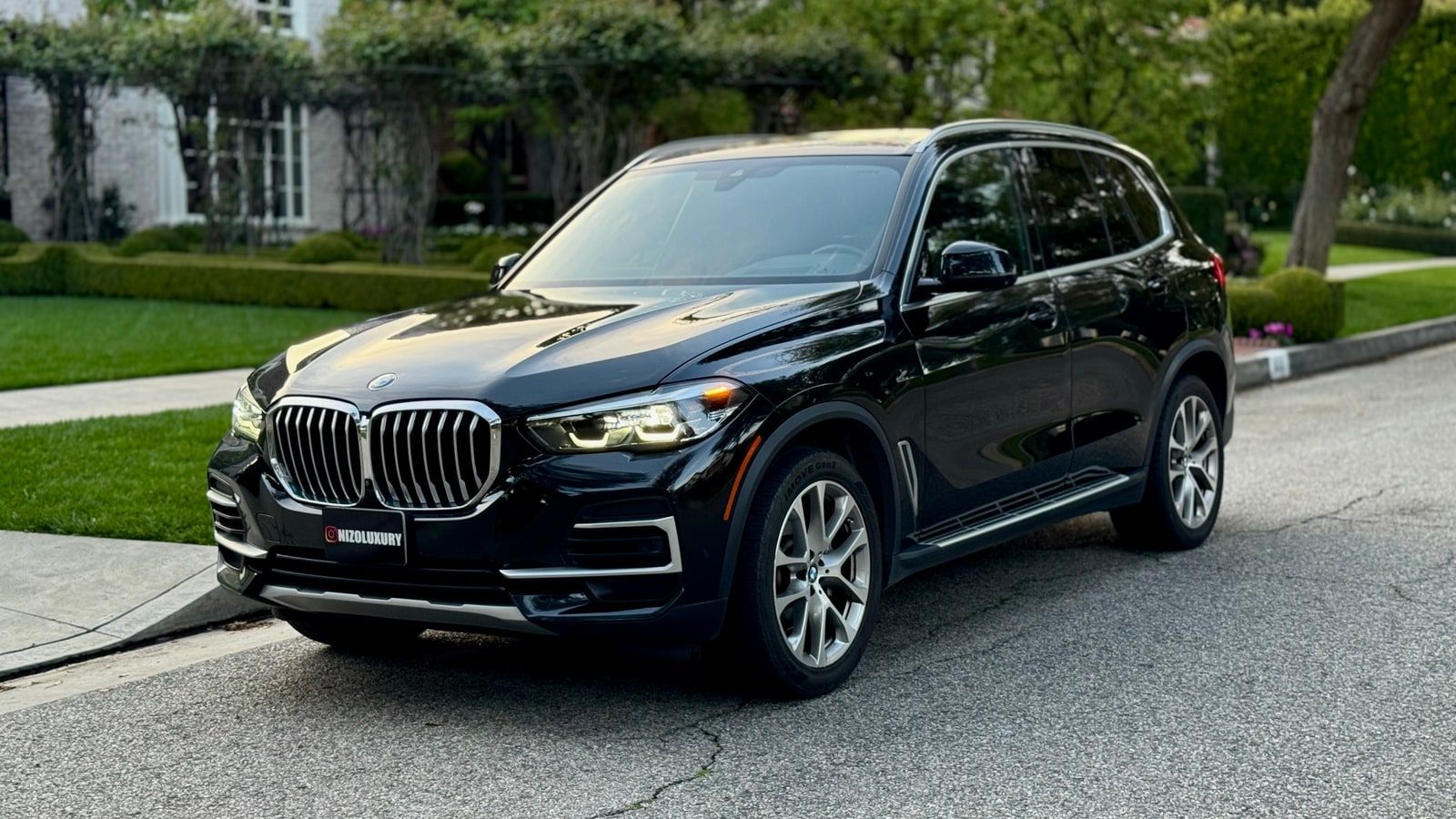 Black BMW X5 on a Los Angeles street, front three-quarter view
