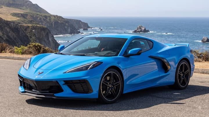 Blue Chevrolet Corvette parked on a coast road
