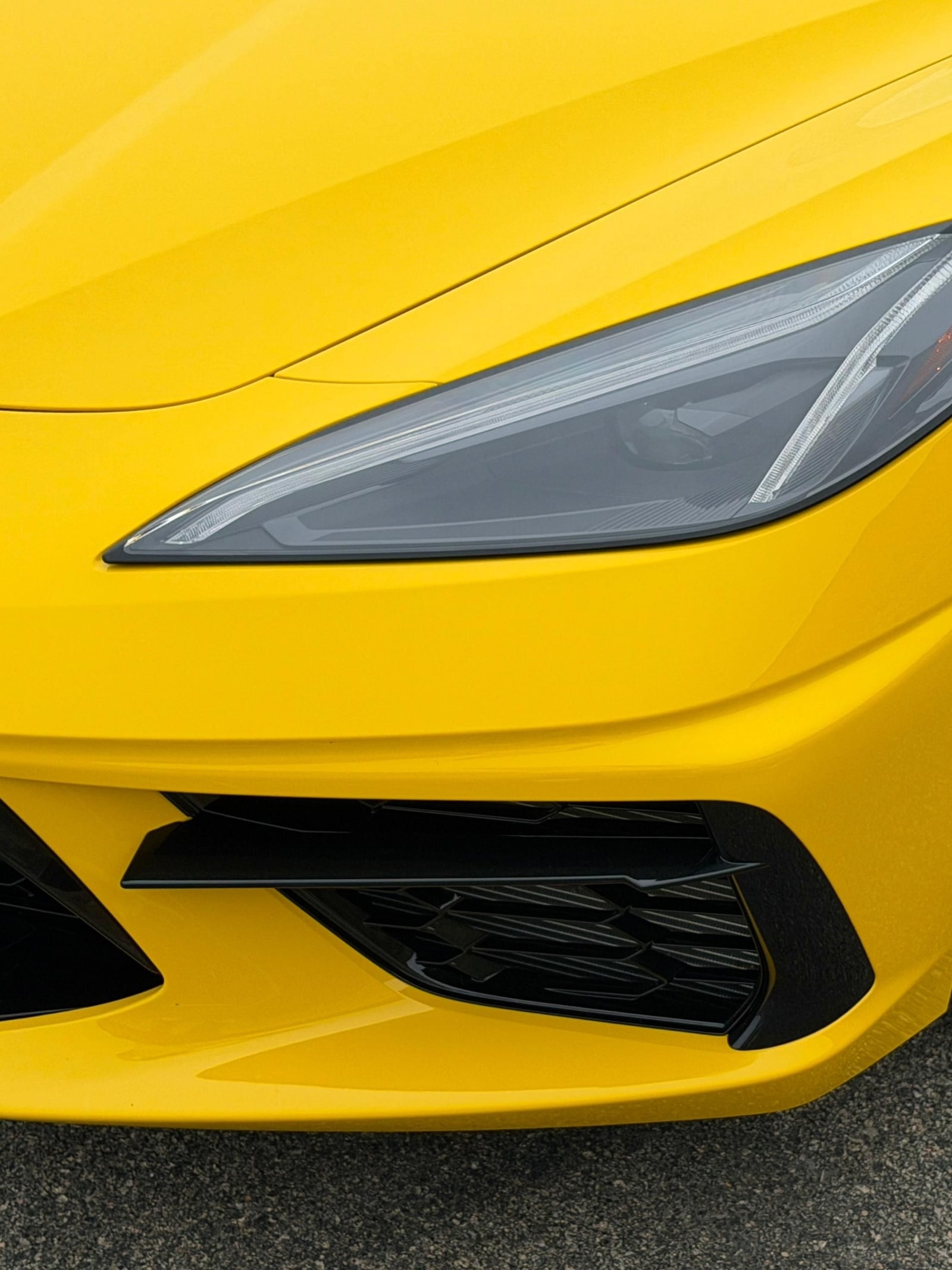 Headlamp and front intake of the yellow Chevrolet Corvette