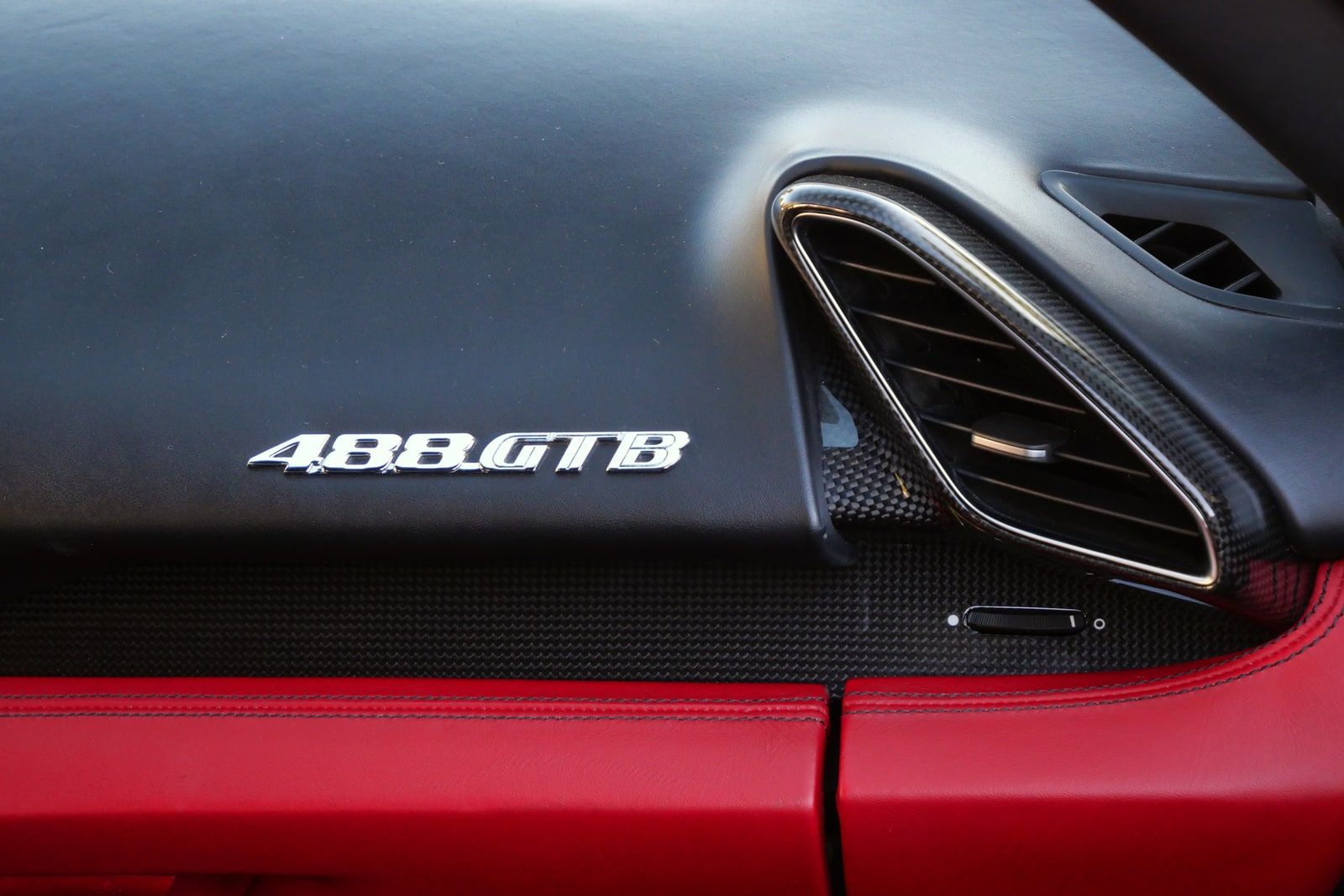 488 GTB badge on the dashboard of the Ferrari