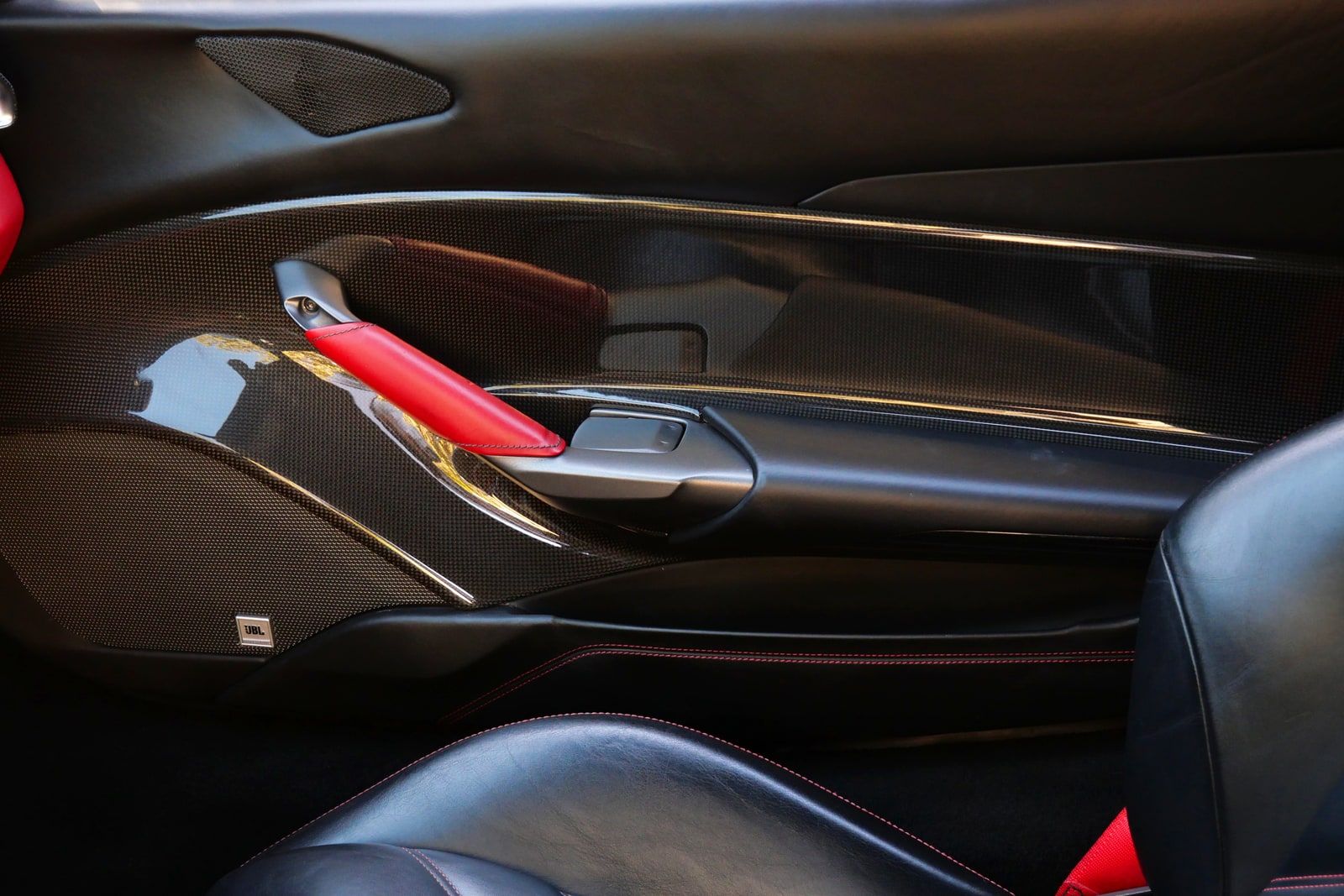 Carbon fibre centre tunnel of the Ferrari 488 with the red launch lever