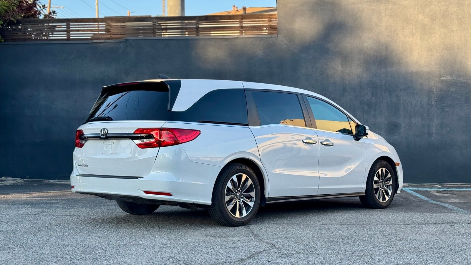 White Honda Odyssey available to rent in Los Angeles, front three-quarter view