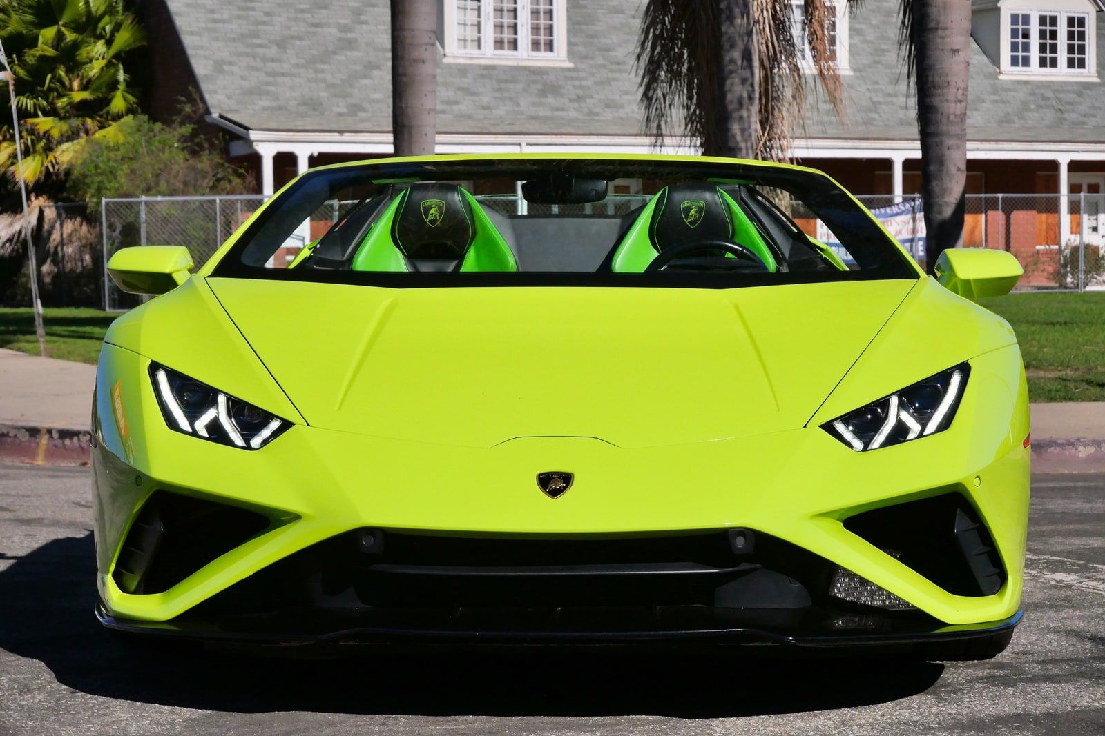 Green Lamborghini Huracán Evo Spyder head-on with the roof down, green seats visible over the screen