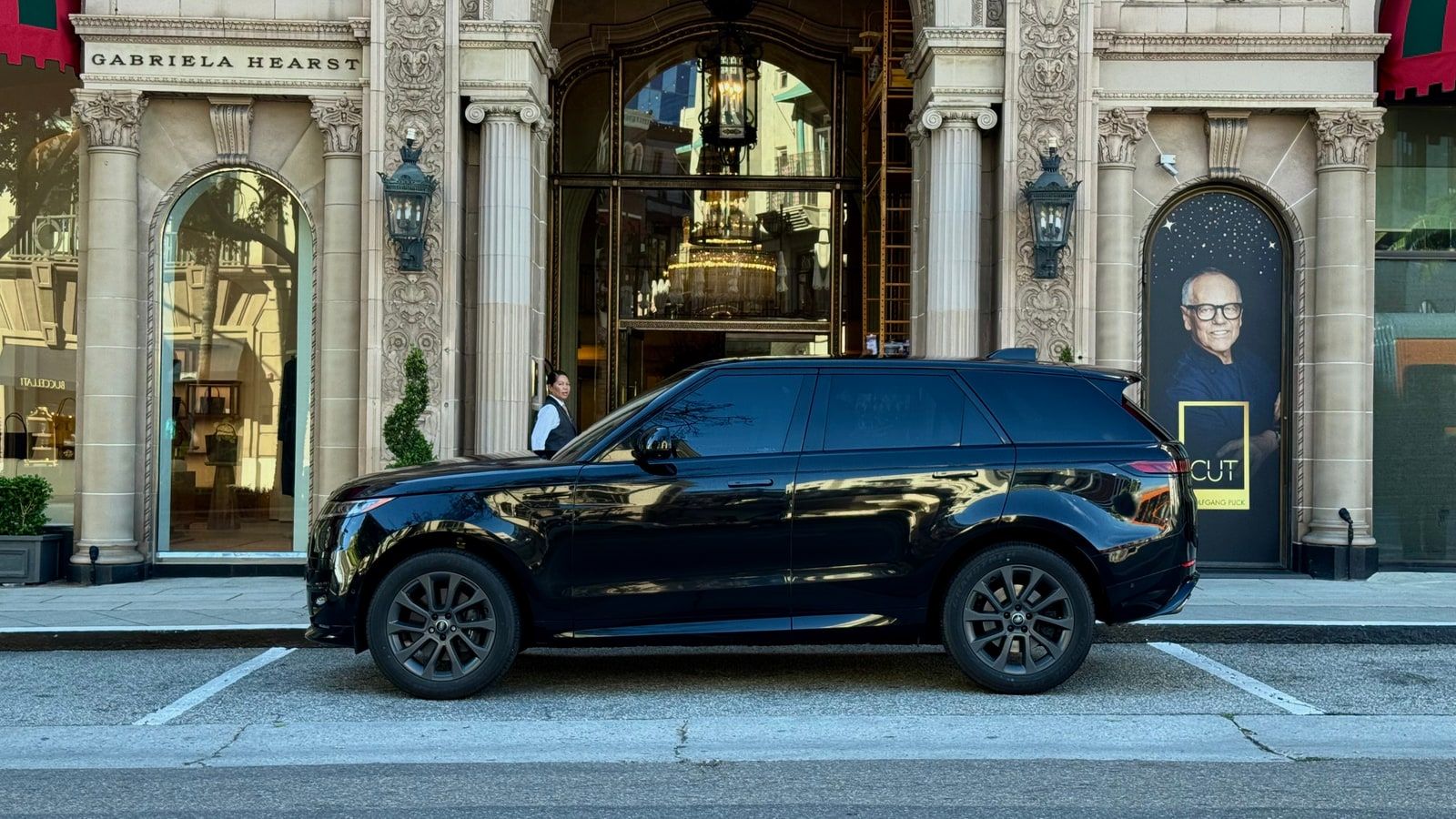 Black Range Rover Sport in profile outside a Beverly Hills boutique