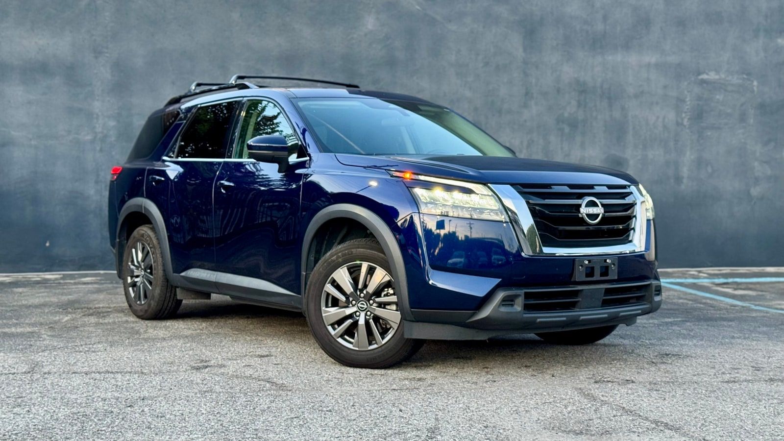 Blue Nissan Pathfinder from a front three-quarter