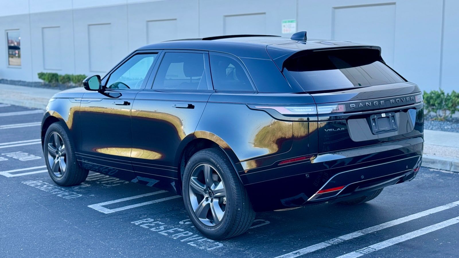 Black Range Rover Velar from the rear three-quarter