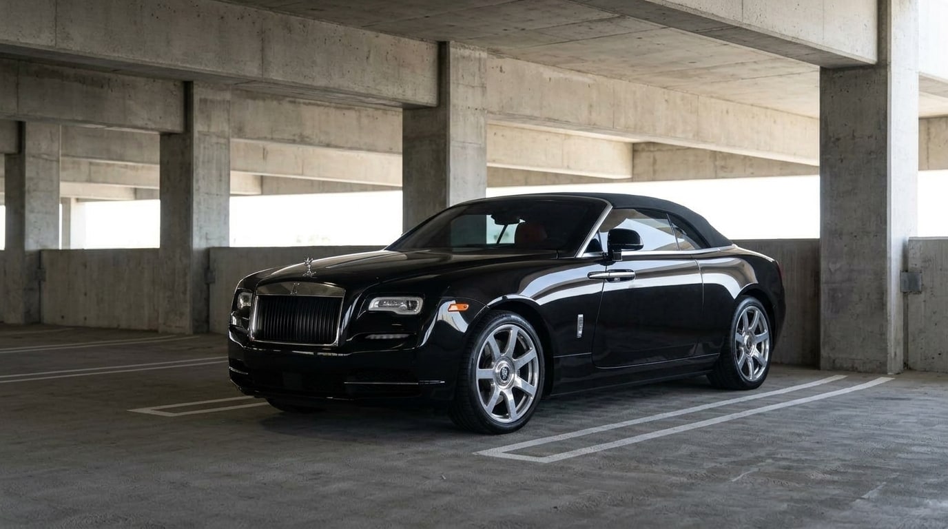 Black Rolls-Royce Dawn parked in an airport parking structure for a standard delivery